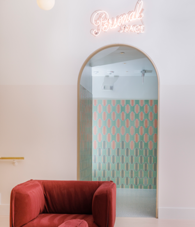 Pale pink room with brick red chair and doorway to area marked "personal space."