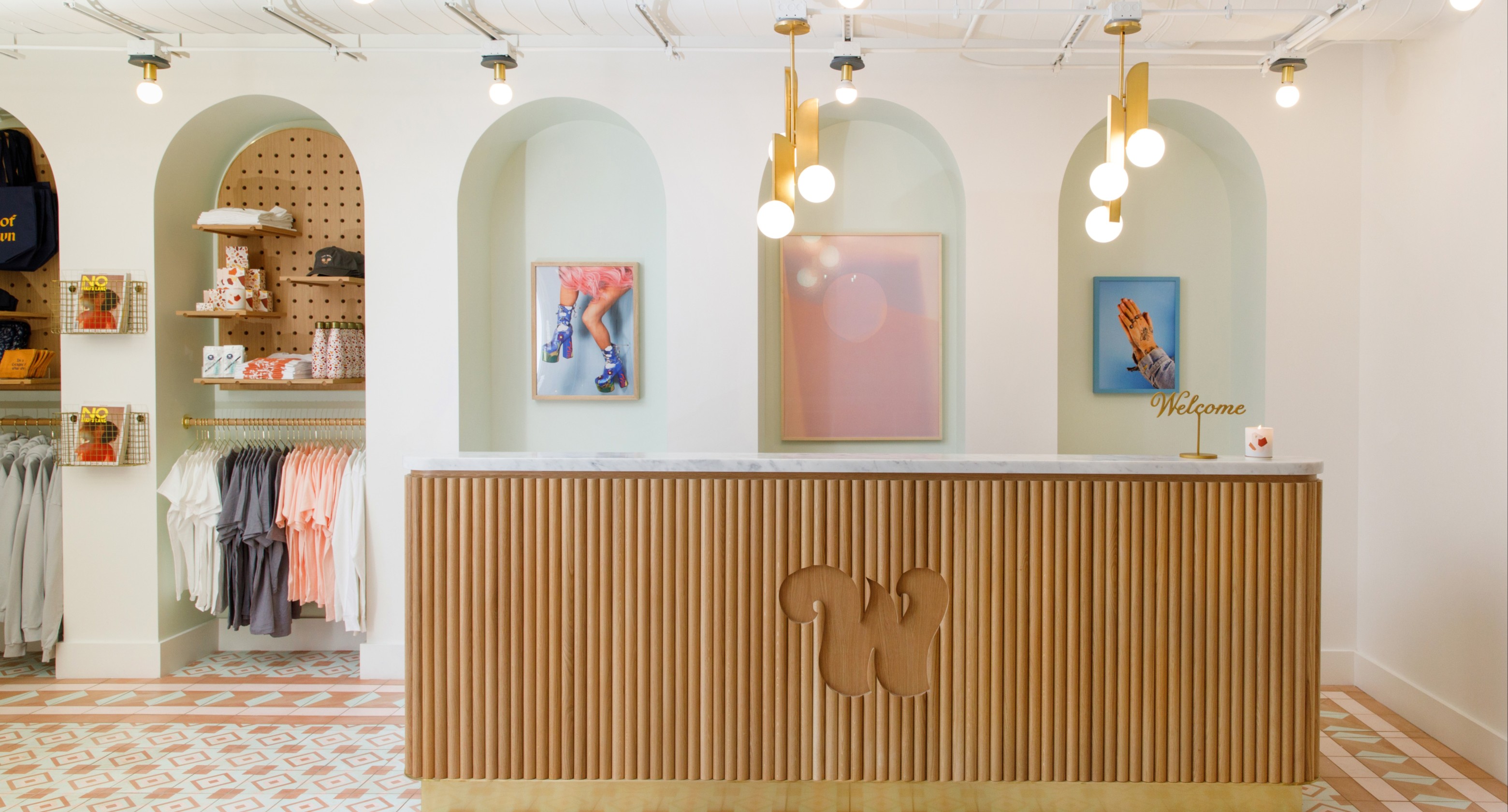 Desk with low-hanging lights and wooden front desk with branded W.