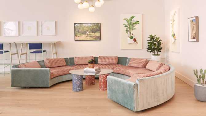 A round couch with ample seating on the new fourth floor of The Wing SoHo.